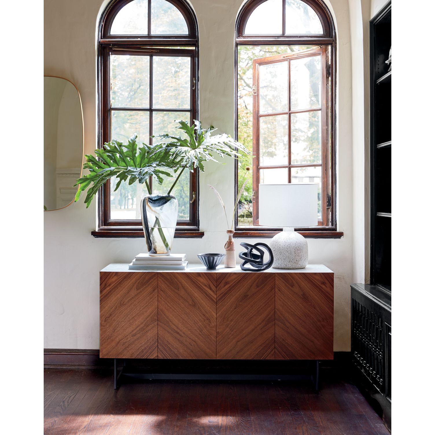 Tropical greenery in a large glass vase