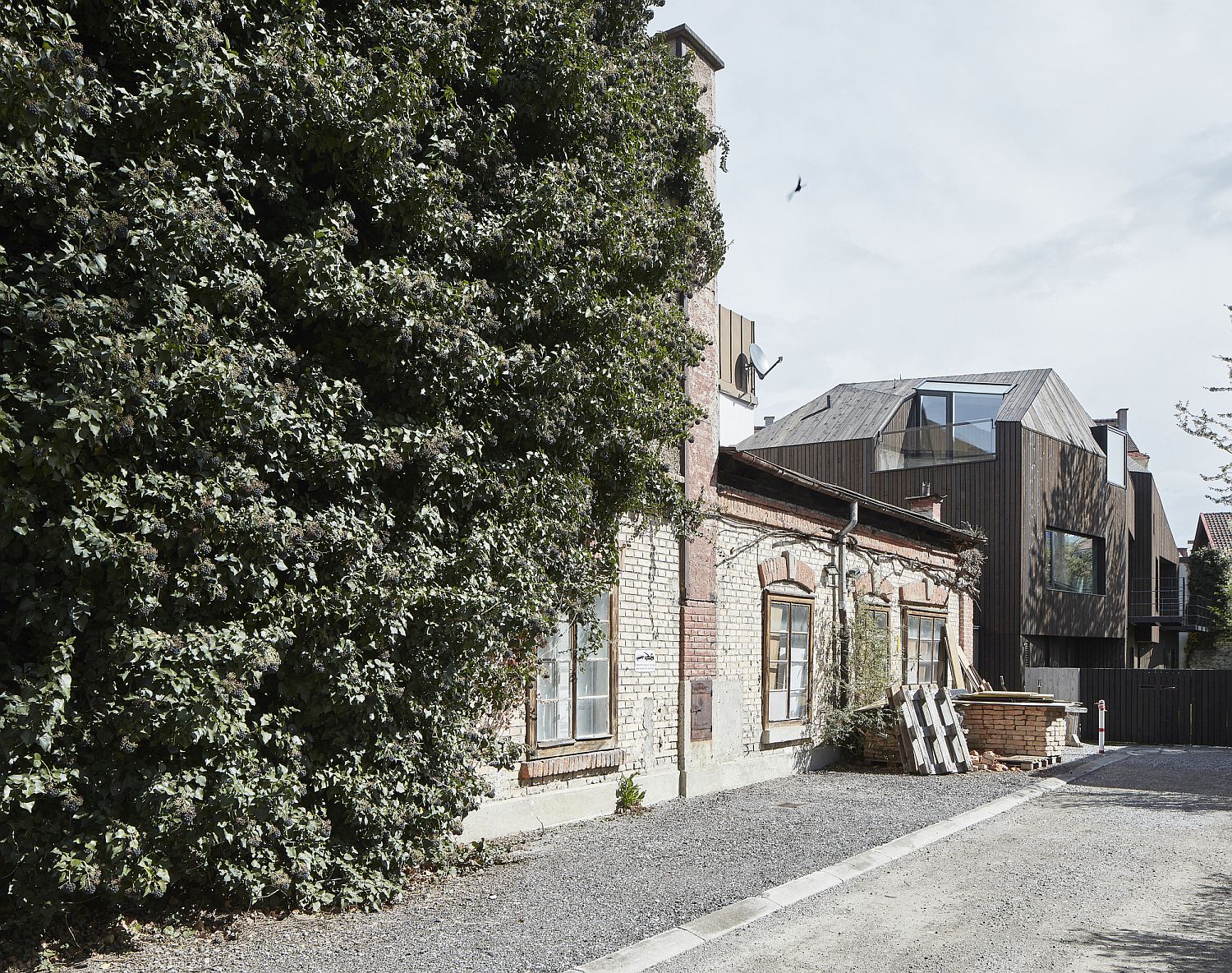 Unique and modern wooden facade of the house is visible from a distance