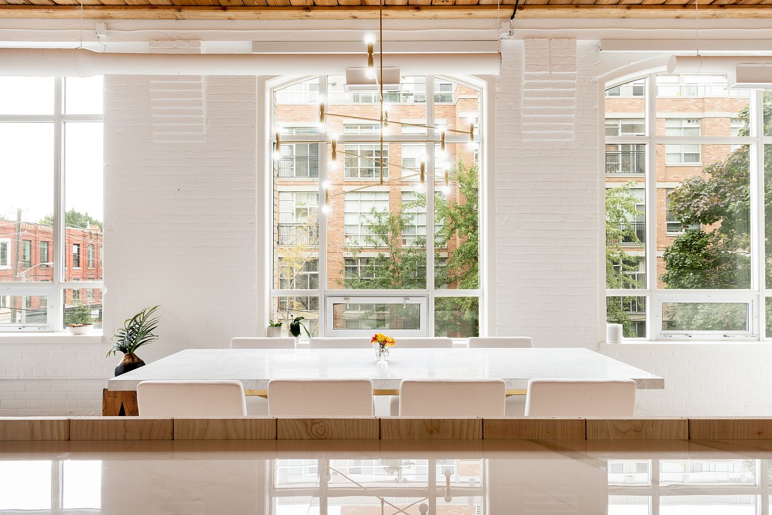 Whitewashed brick walls and large windows of the downtown Toronto loft