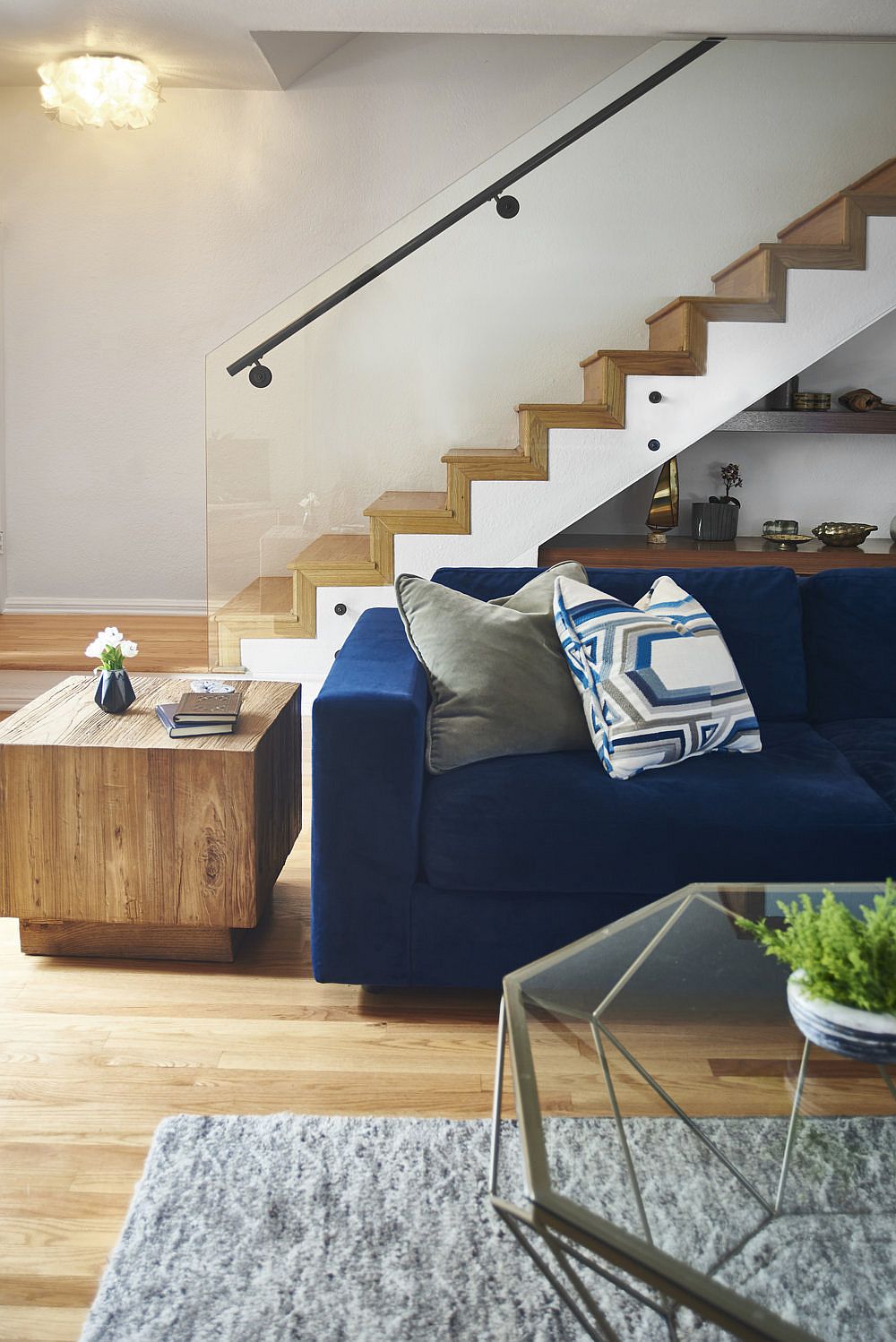 Wooden staircase creates a stylish and striking backdrop for the living room