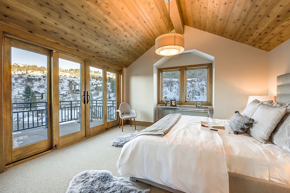 Balcony outside adds to the spaciousness of the bedroom in wood and white