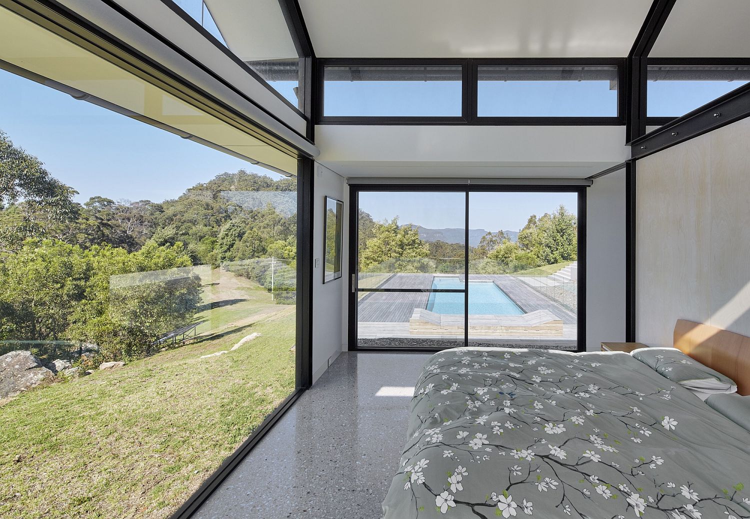 Bedroom with a sweeping view of the pool area and the valleys beyond