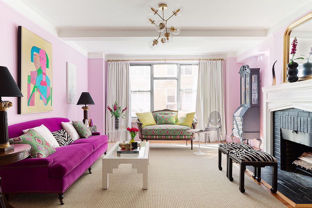 Bright pink walls for the eclectic living room draws your attention instantly