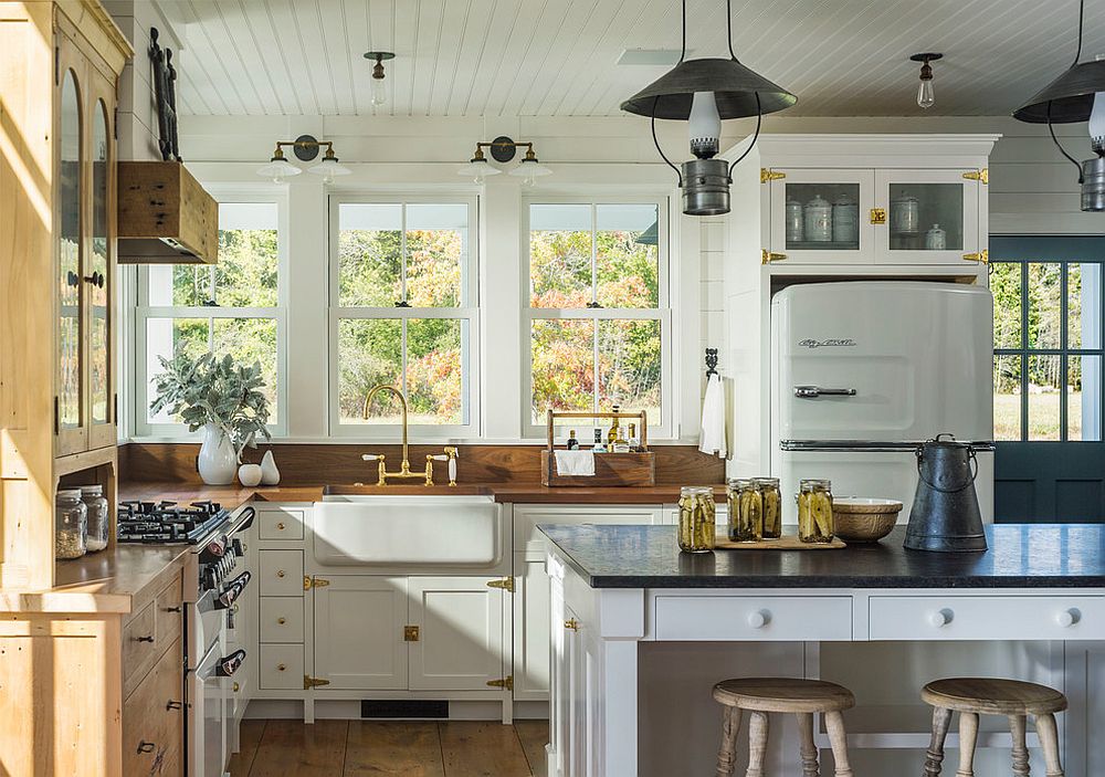 Cabinets and countertops bring woodsy element to the white farmhouse kitchen