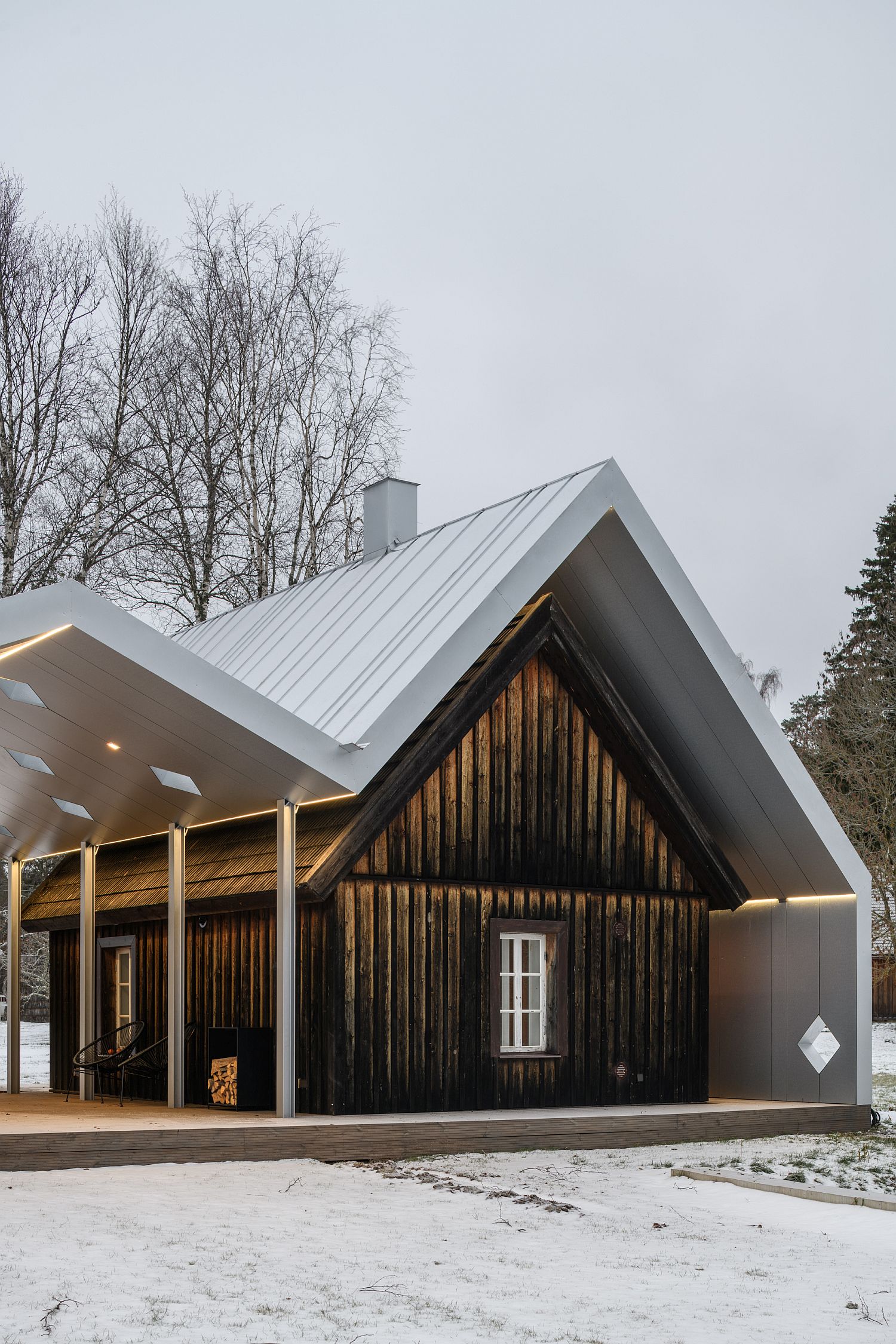 Dark sauna room stands out visually when compared to its brighter, more modern couterpart