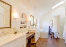 Golden-accents-add-brightness-to-bathroom-in-white-with-skylights-and-terracotta-tiles-217x155
