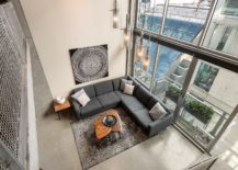 Gray-sectional-inside-the-living-room-fits-in-perfectly-with-its-concrete-centric-theme-217x155
