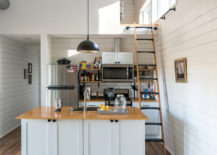 Kitchen-with-sleeping-area-above-inside-the-tiny-house-217x155