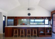Kitchen-with-wooden-island-and-a-lovely-green-tiled-backsplash-217x155