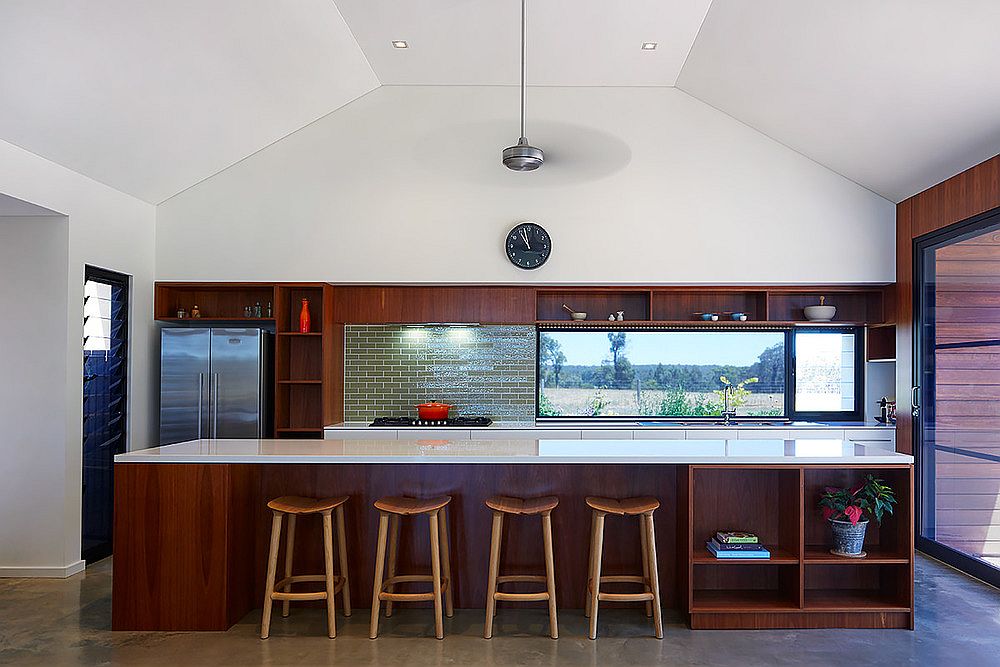 Kitchen with wooden island and a lovely green tiled backsplash