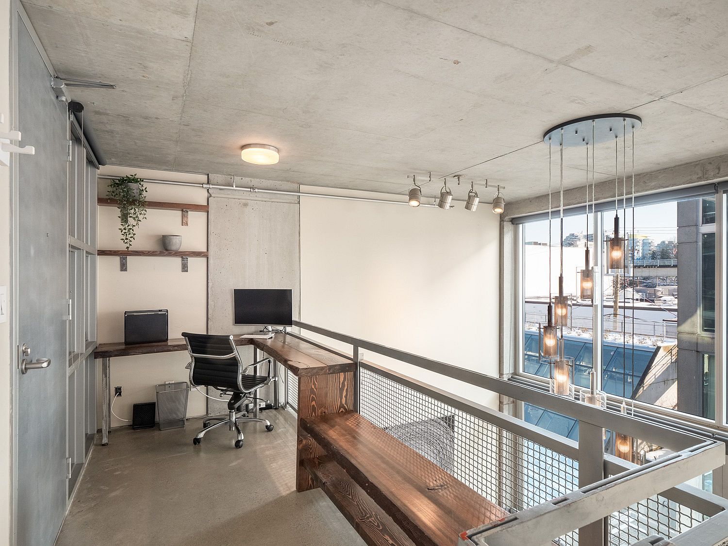 Loft level of the apartment with a view of the living area and beyond