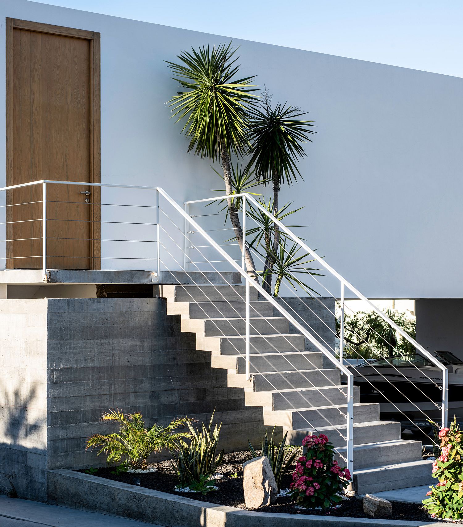 Natural greenery adds color and character to the entrance