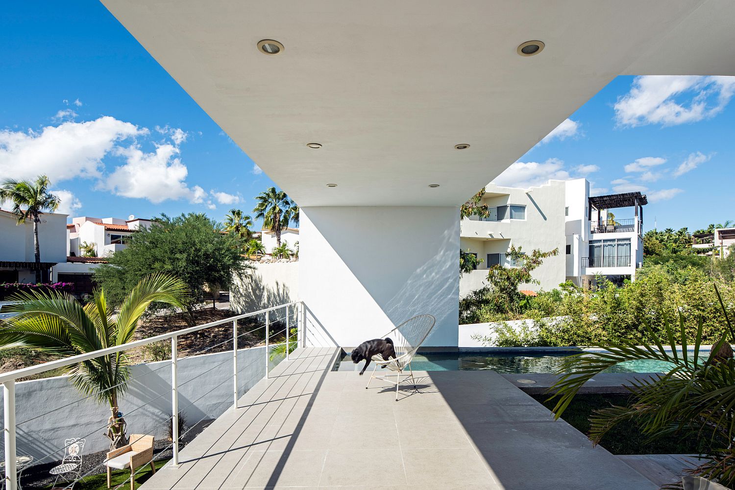 Open outdoor spaces and sheltered walkways around the house create sitting areas