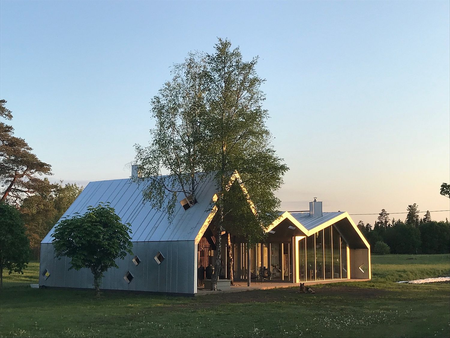 Sauna complex next to farmhouse in Estonia with a modern addition