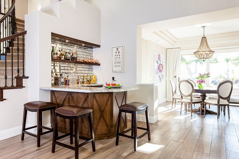 Space under the stairway turned into a smart and simple home bar with ample shelf space