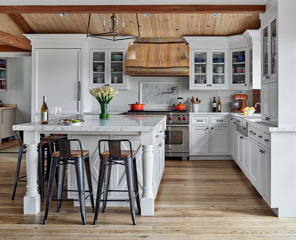 Spacious and well-lit farmhouse style kitchen in white and wood