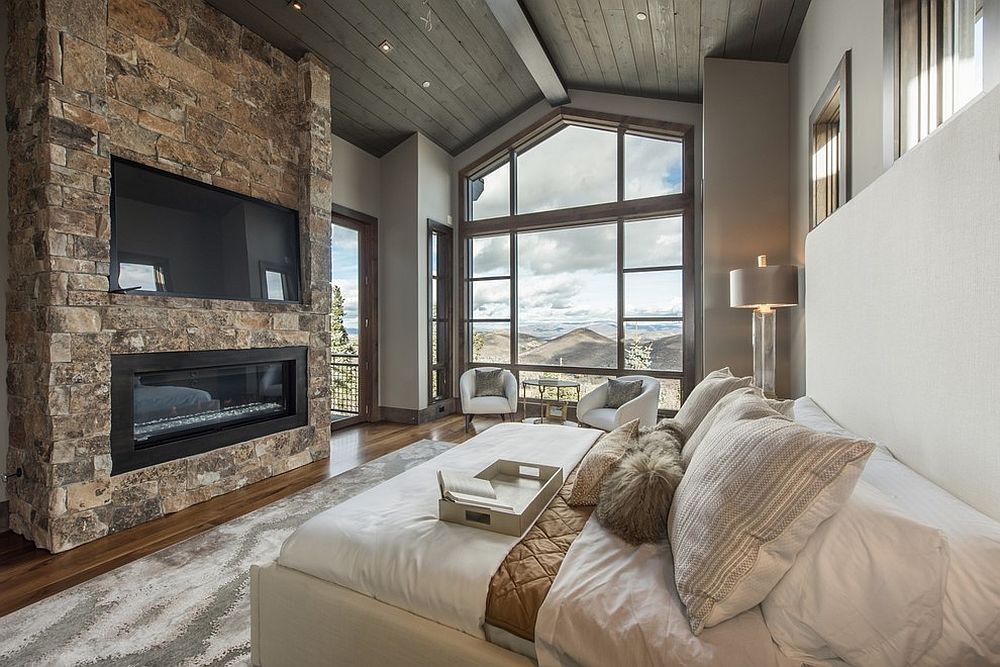 Stone wall with TV and fireplace for the modern rustic bedroom that offers ample luxury