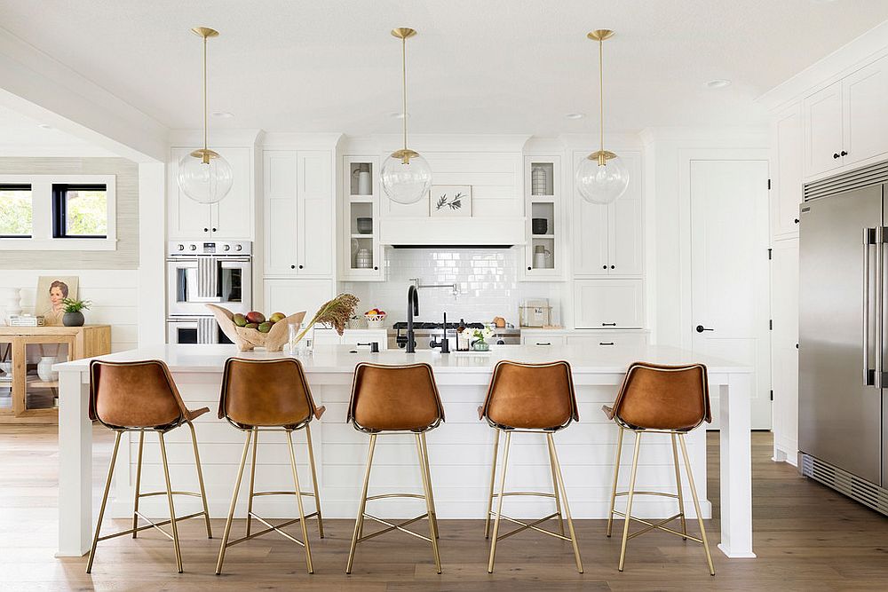 Striking use of leather bar stools in the modern farmhouse kitchen in white