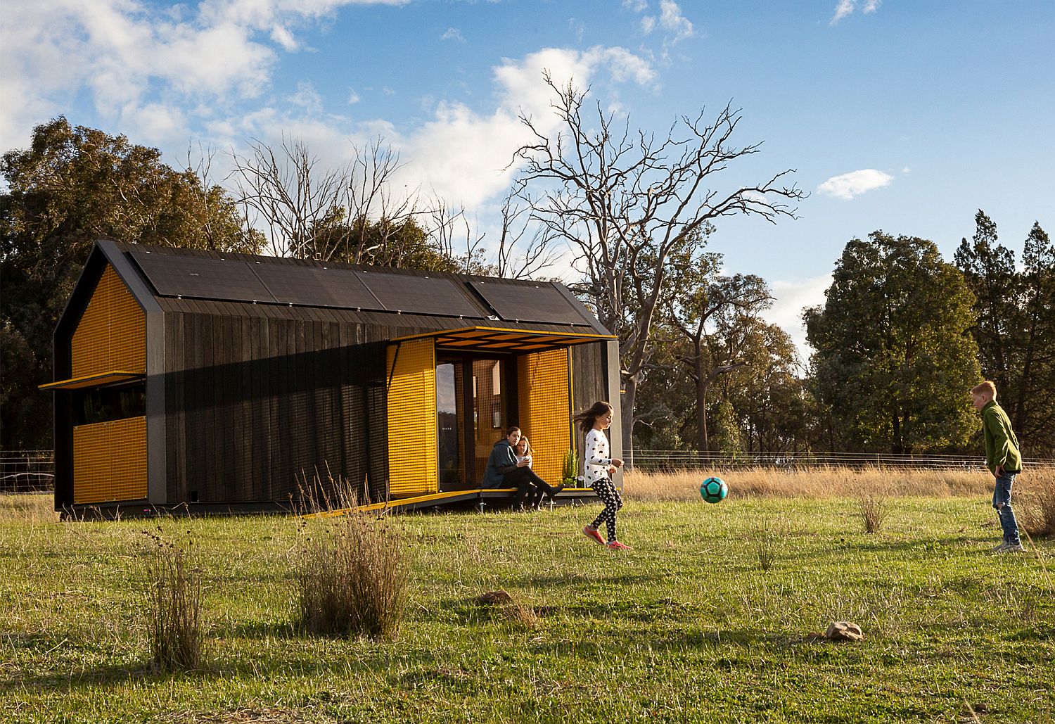 TIny-home-with-gable-roof-and-yellow-shades-that-can-be-controlled-with-a-smart-device