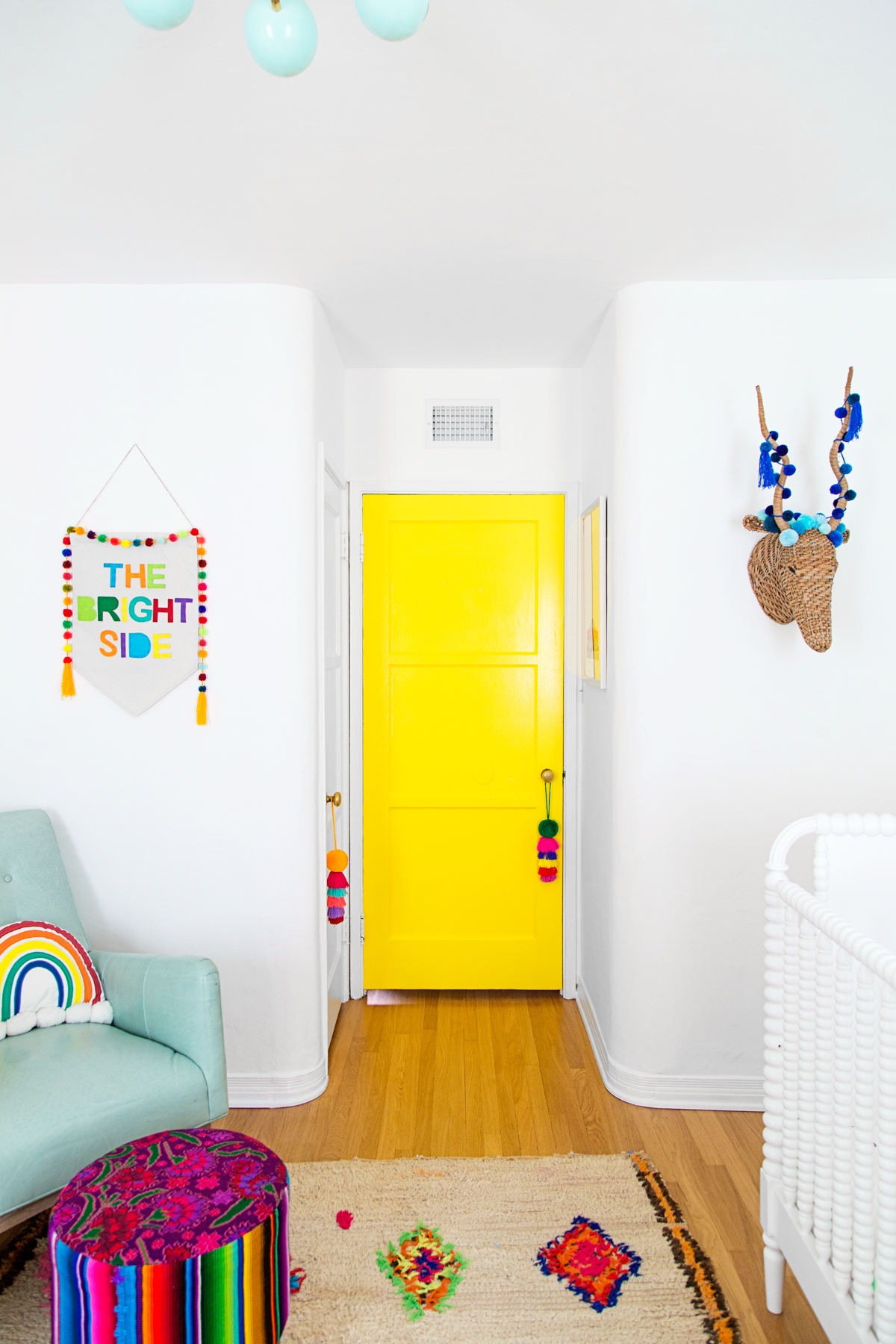 Tassels and pom poms in a nursery by Studio DIY