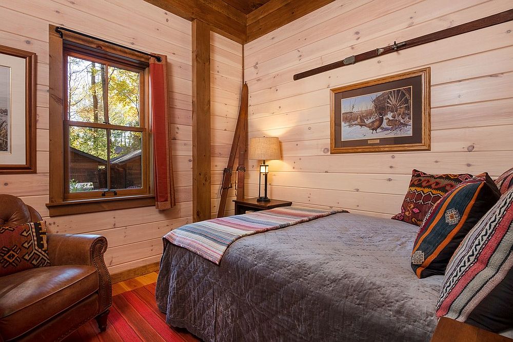 Walls-in-wood-bring-warm-glow-to-the-small-modern-cabin-bedroom