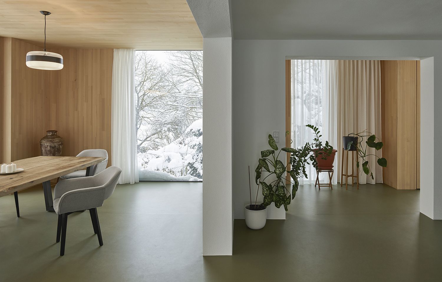 Wooden covering on the walls delineates the dining room visually