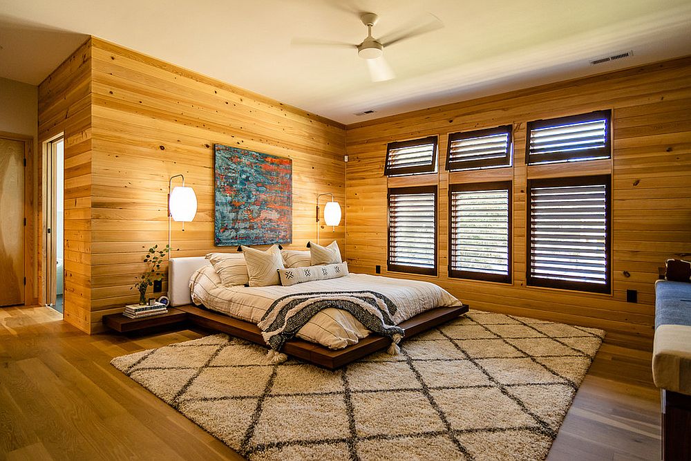 Wooden walls and platform bed give the room a stylish vibe