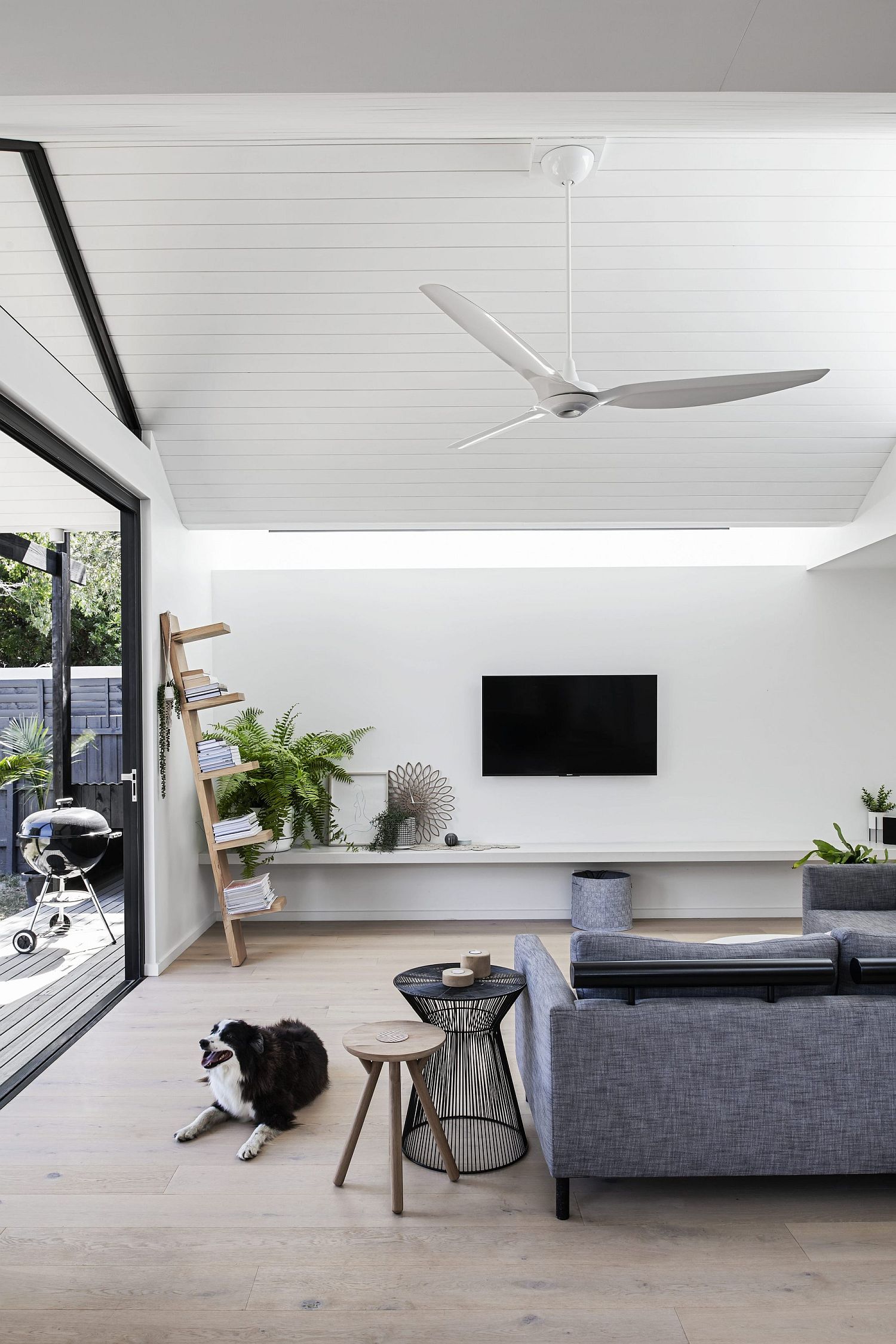 All-white living area of the new extension with a gray couch