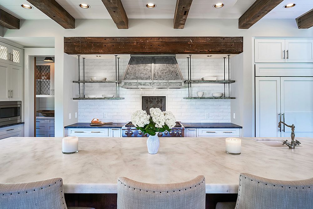 Ceiling beams bring visual contrast to the kitchen in white