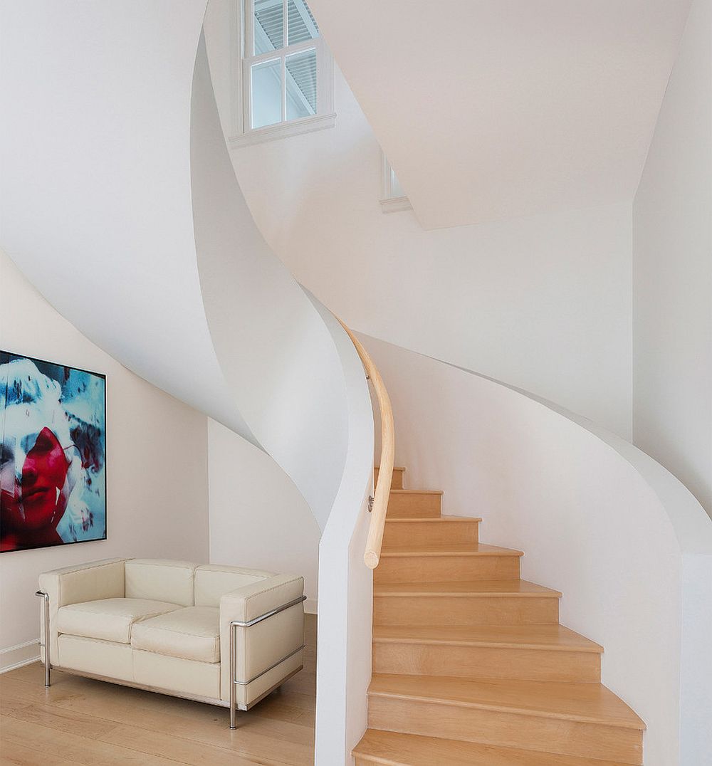 Couch under the spiral staircase offers a lovely sitting space