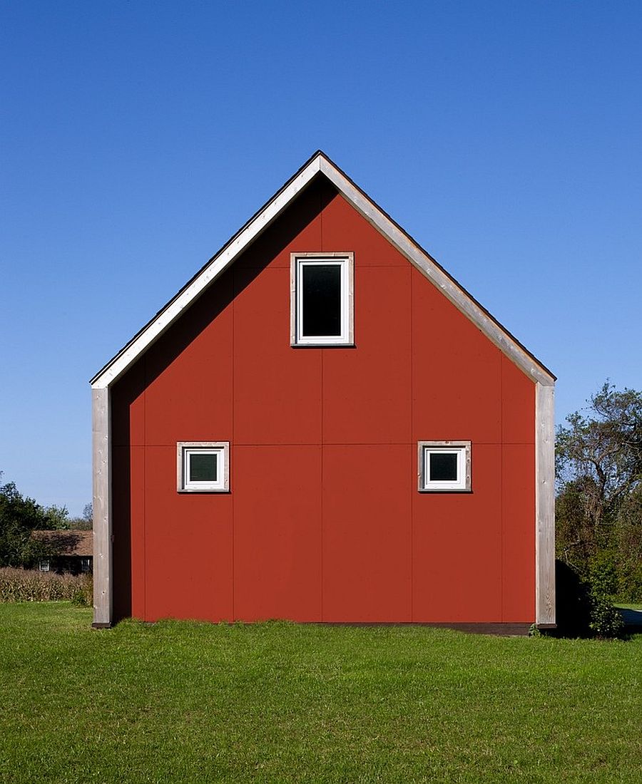 Eco-friendly home with farmhouse style and a red exterior