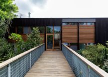 Entrance-to-the-revamped-1950s-Cowey-House-with-a-wooden-bridge-and-smart-insulation-217x155