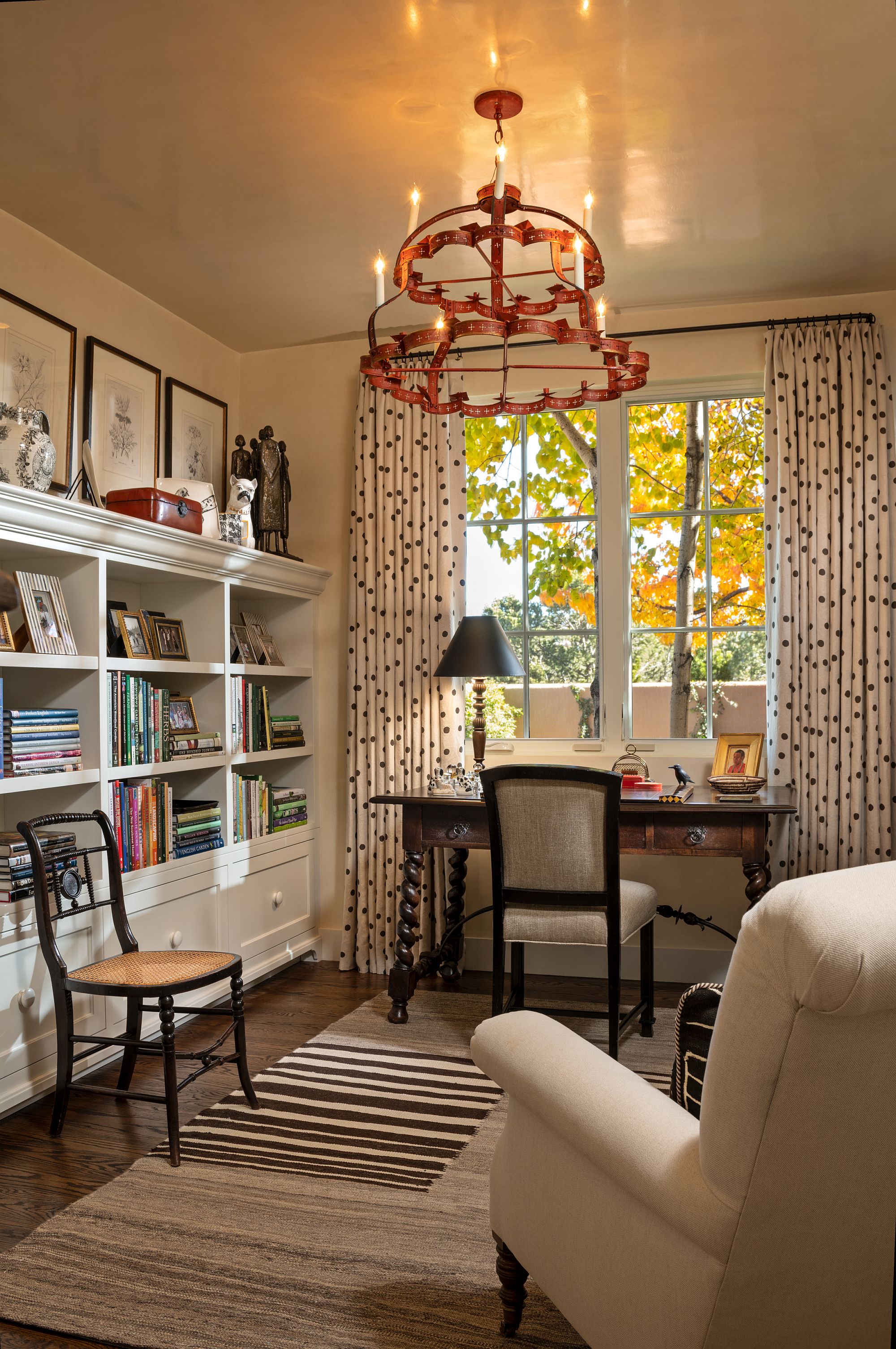 Home office in comfy, neutral hues and a chandelier that steals the spotlight