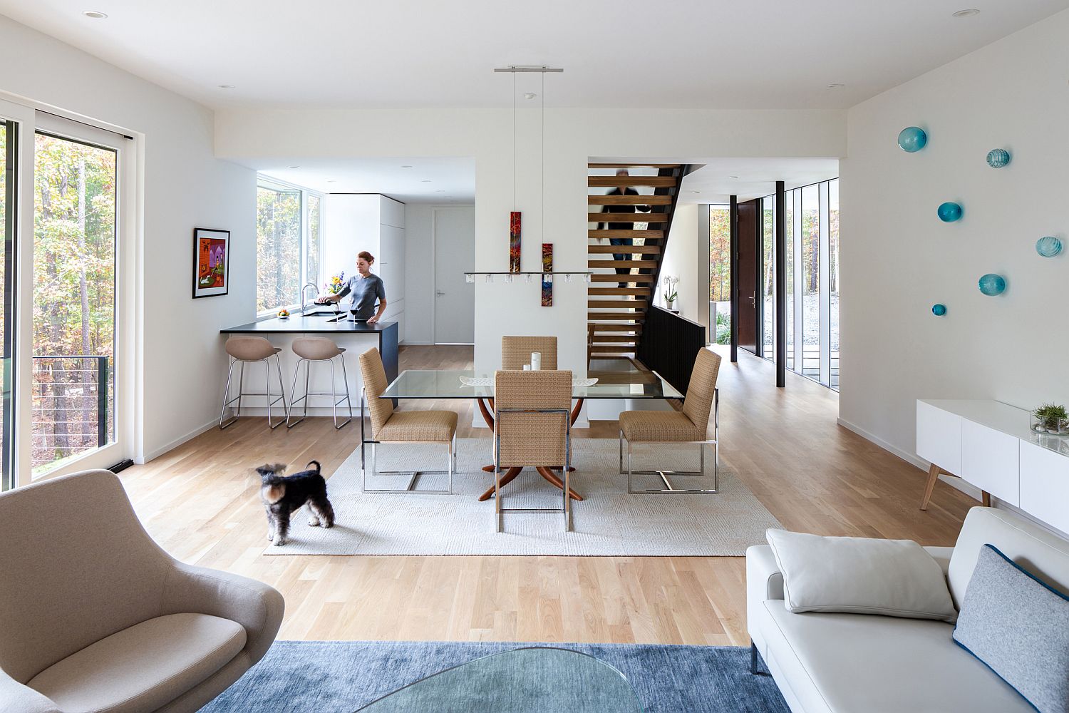 Kitchen, dining area and living space in white and wood with pops of blue