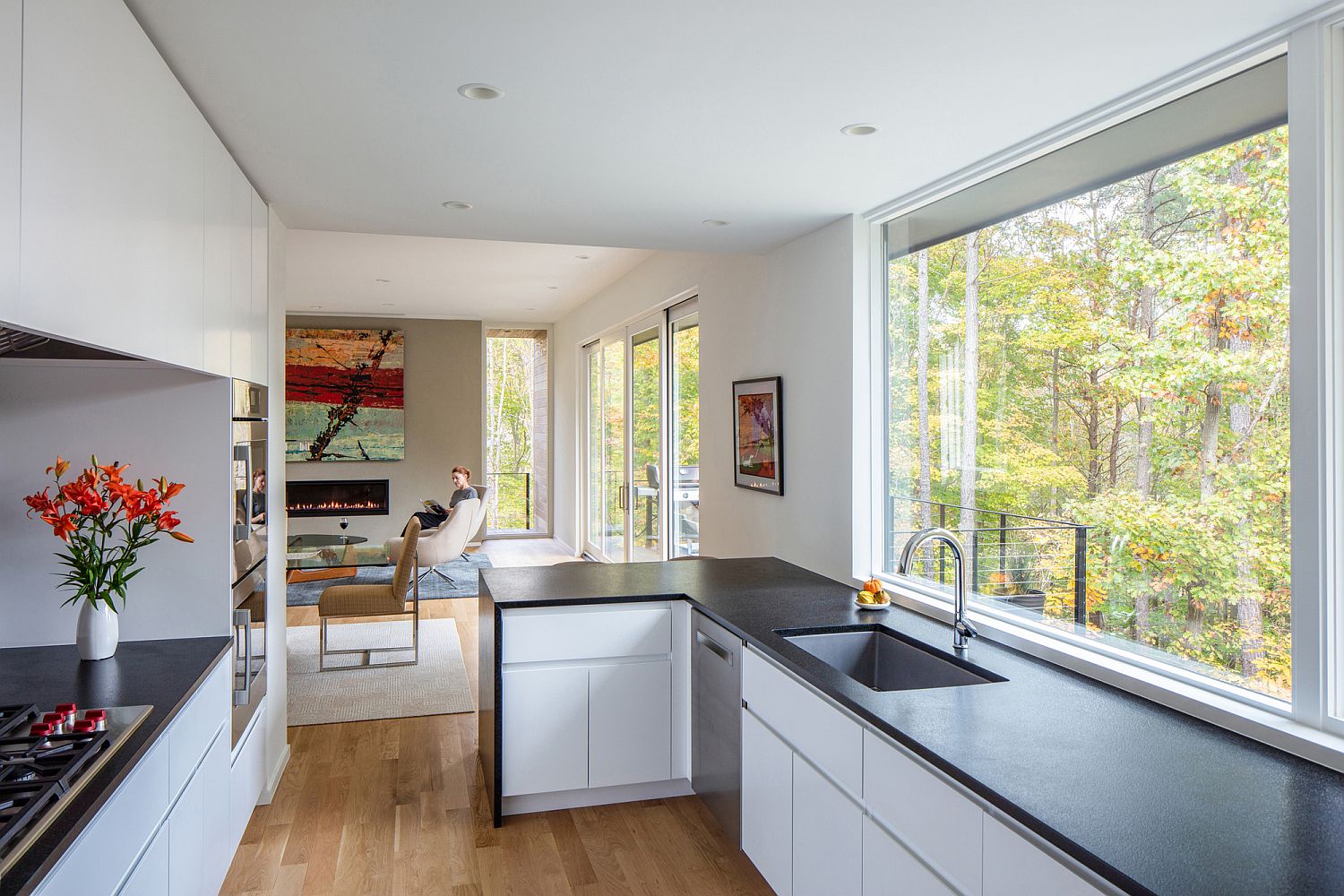 Kitchen in the corner makes most of available space while offering lovelys views of the woods