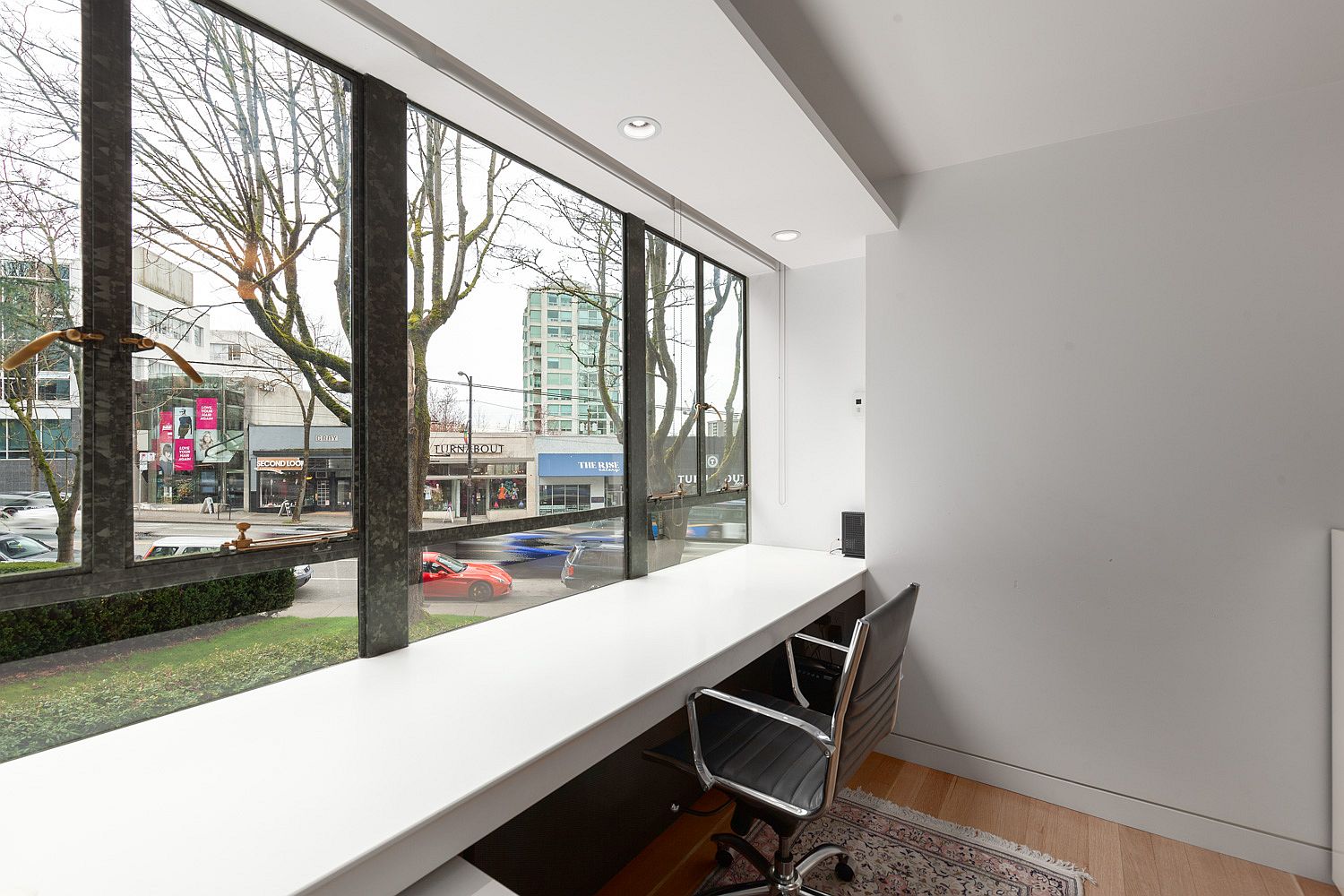 Large window brings natural light into the second bedroom and home office