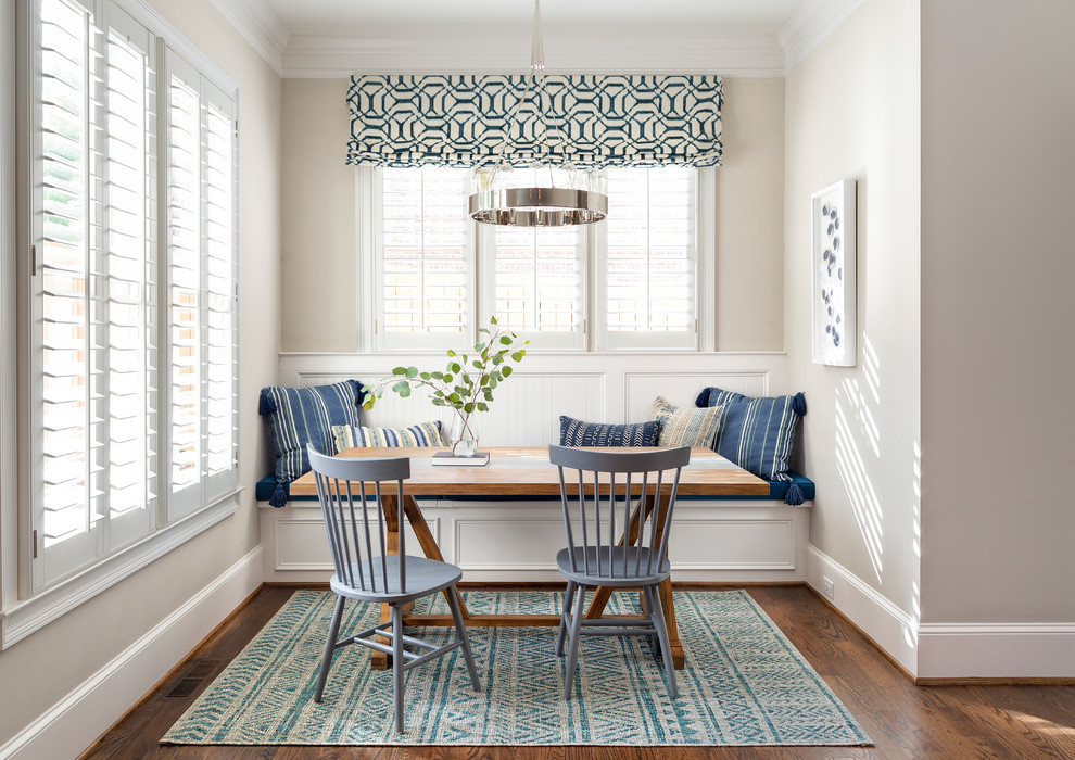 Light-filled beach style dining room in white with pops of blue