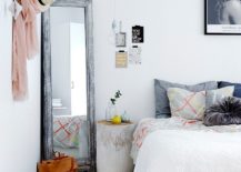 Minimal-bedroom-with-mirror-in-corner-and-backdrop-in-white-217x155