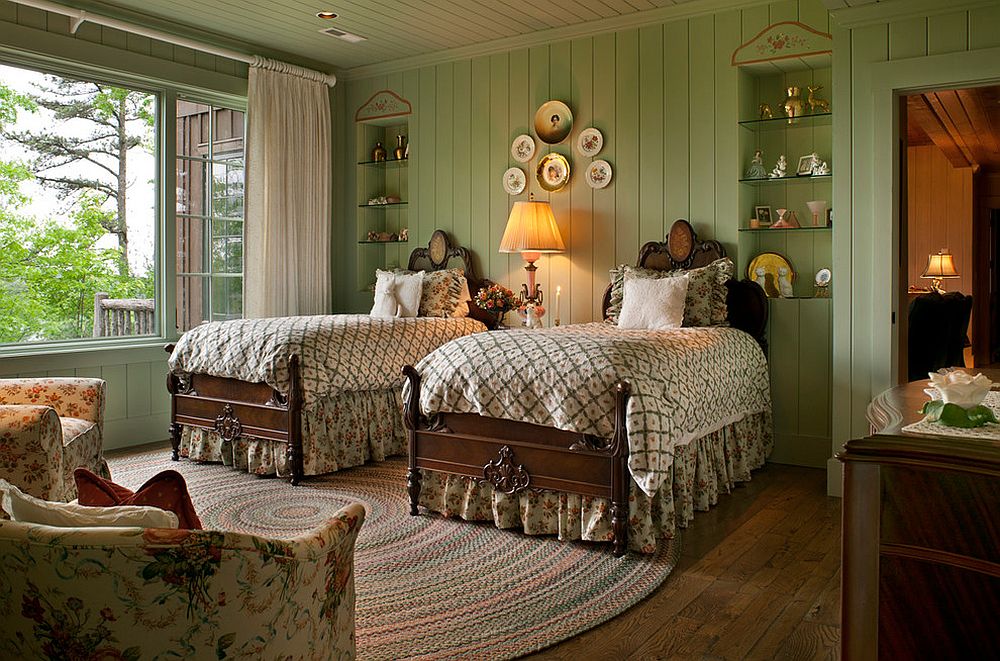 Rustic bedroom in green with flowery pattern brought in by the armchairs