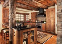 Rustic-kitchen-in-wood-with-ceiling-beam-and-black-countertops-217x155