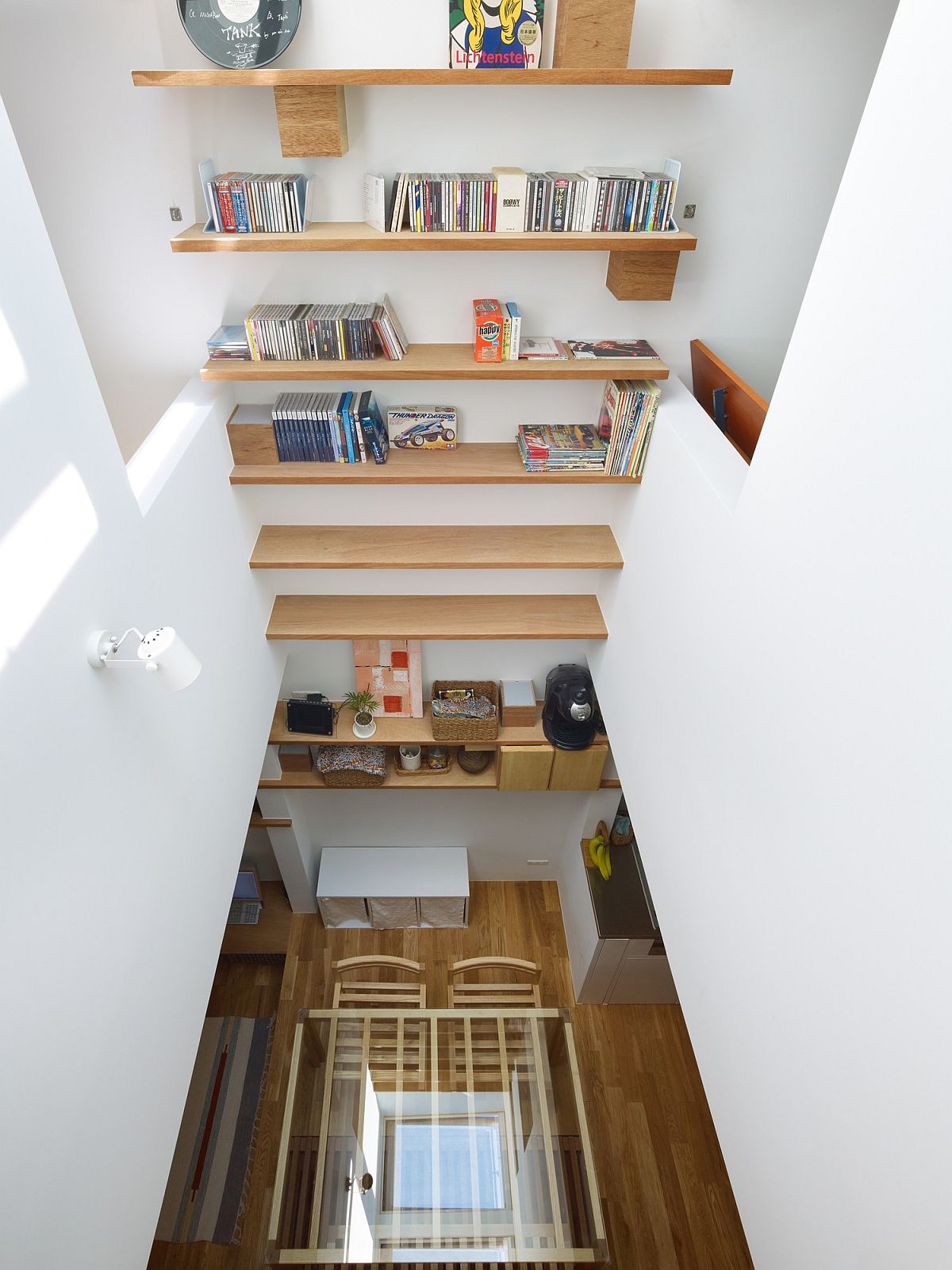 Slatted tables stairwell provides storage space along with a lovely display