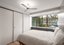 Sliding-closet-doors-in-white-give-the-bedroom-a-space-savvy-appeal-217x155