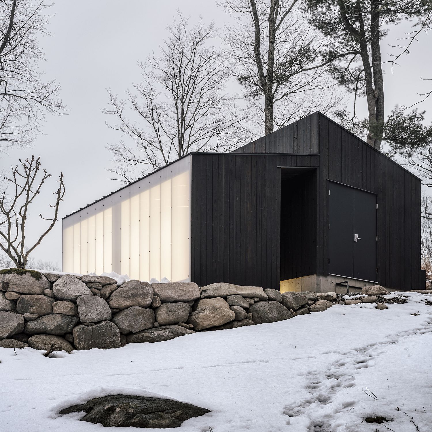 Stone-wood-and-polycarbonate-come-together-beautifully-at-this-small-pavilion