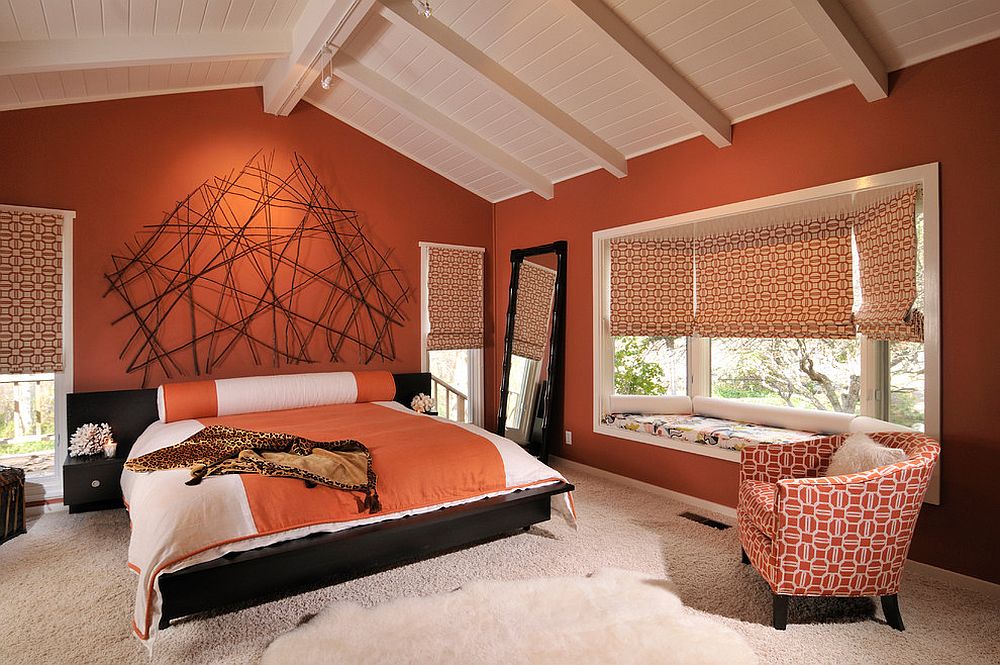 Stunning use of orange in the spacious modern bedroom with ceiling beams