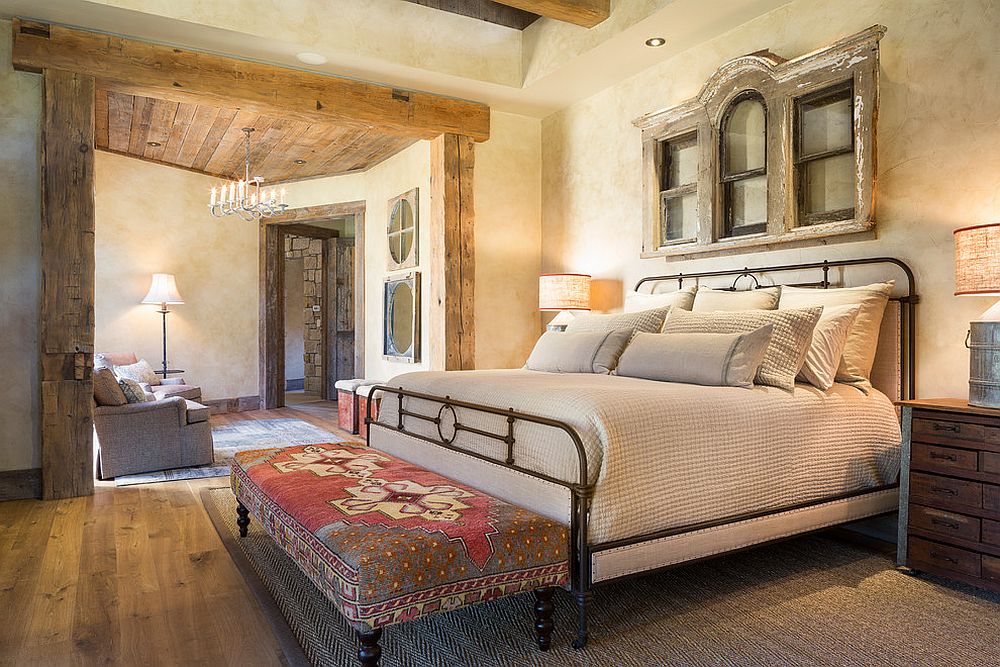 Textured walls and wooden ceiling beams create a cozy, gorgeous bedroom