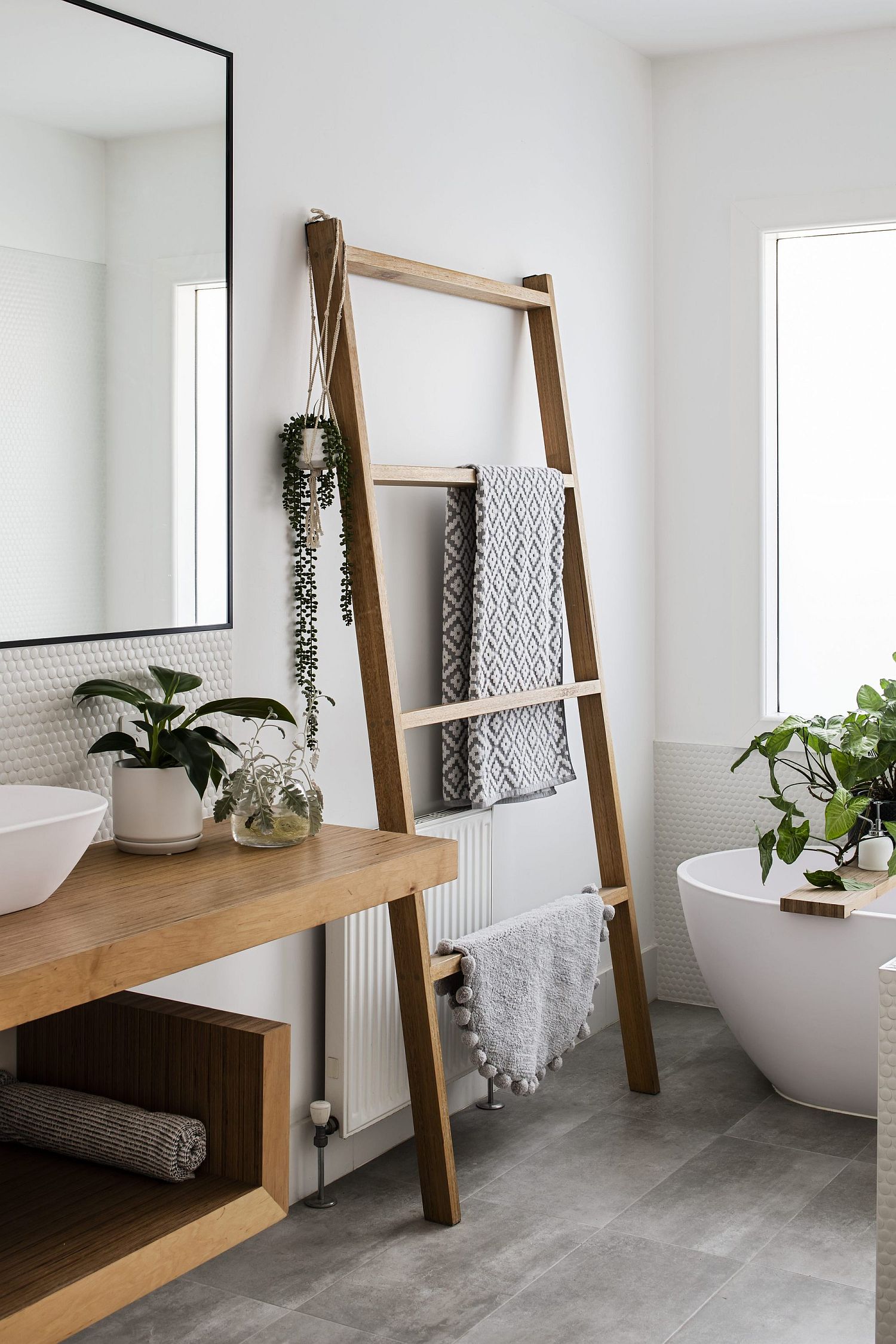 Two new contemporary bathrooms added to the house with white and gray taking over