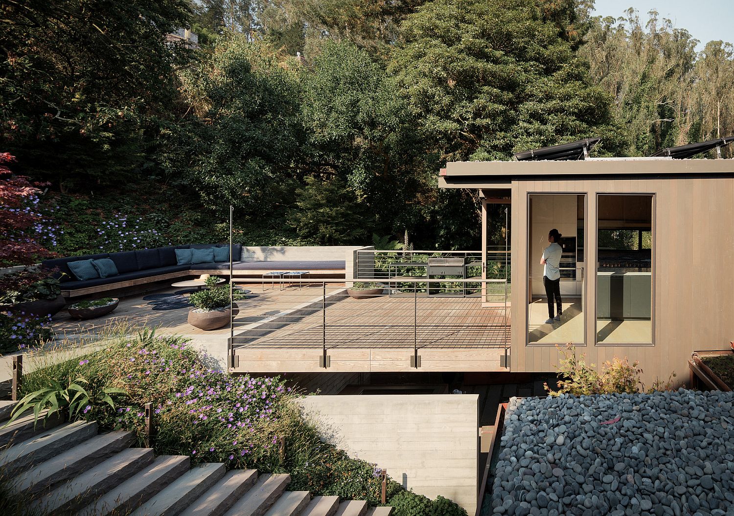 Upper level deck with garden all around and stairway leading to the outdoors