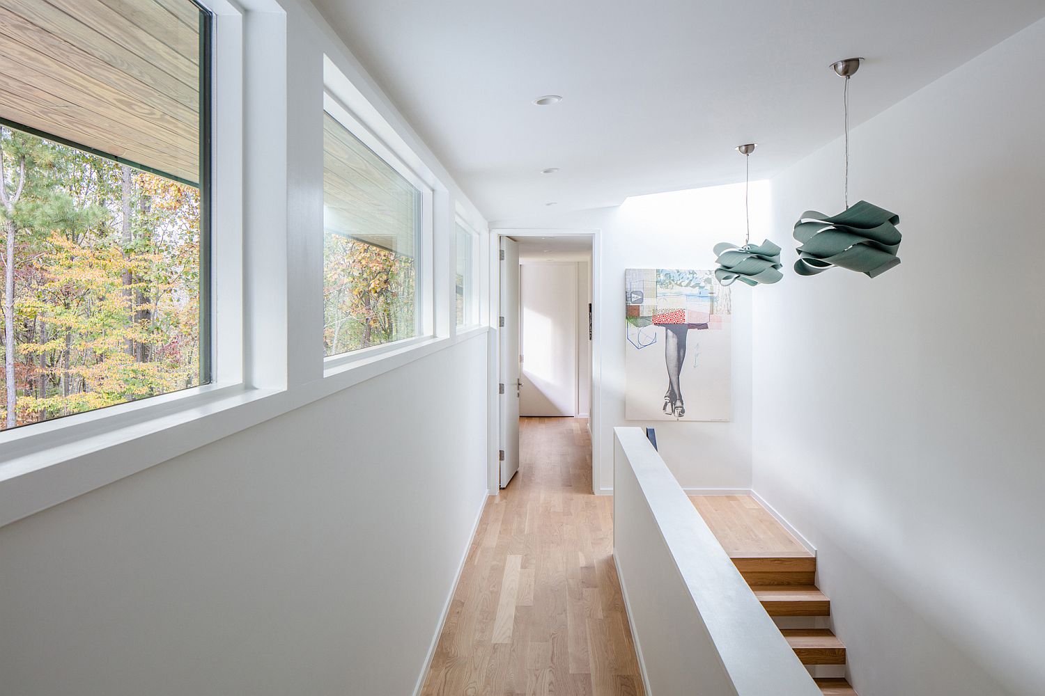 White backdrop and wooden floors give the interior a spacious, light-filled look