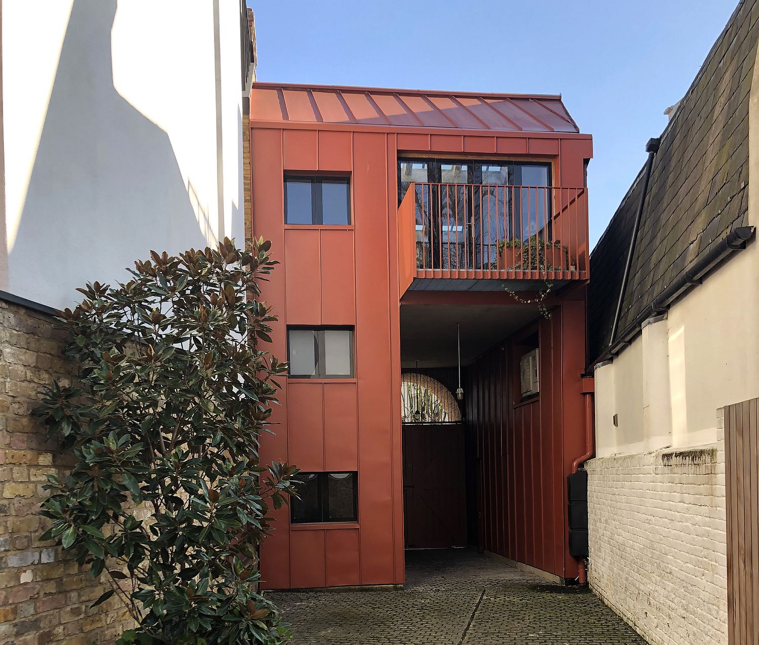 Bright orange metallic facade of Gate House in UK