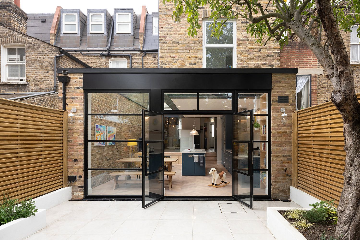 Contemporary rear extension in glass and steel for the classic British home